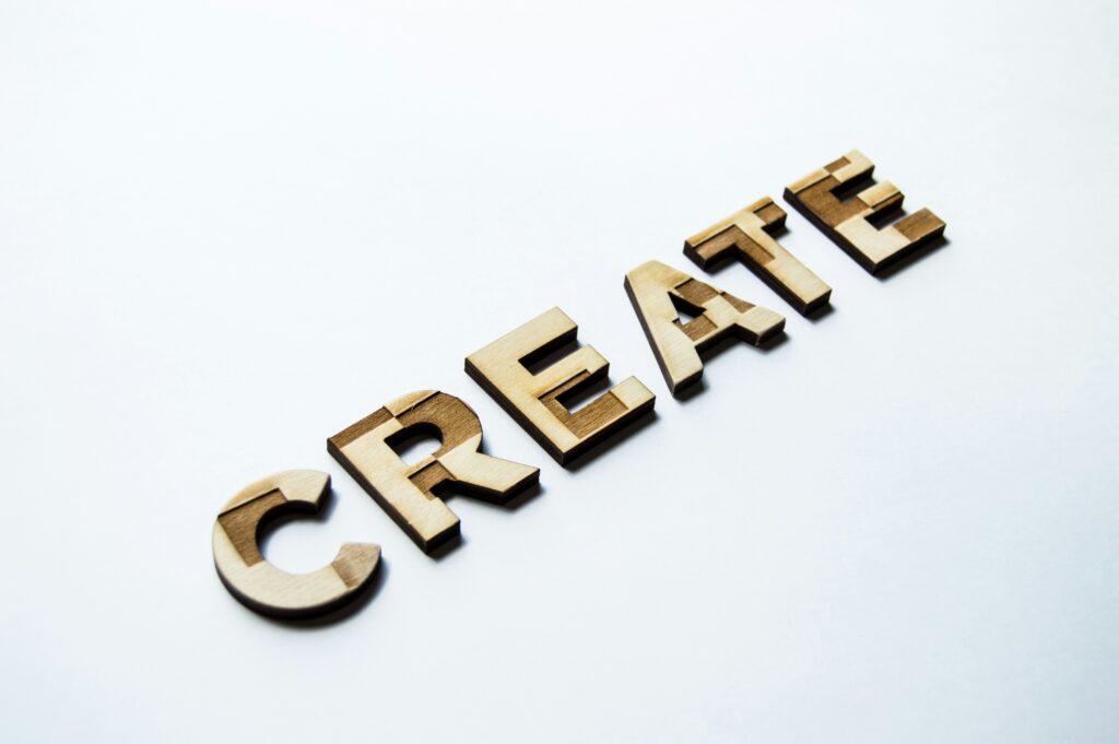 A laser-cut set of wooden letters that spell “CREATE”