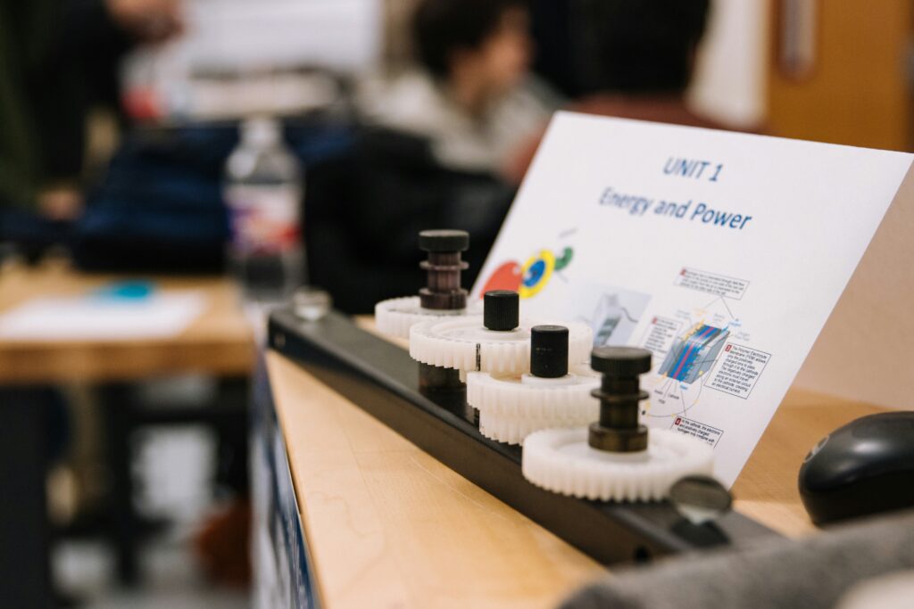 Gears and components accompanied by a paper placard for a learning unit on energy and power