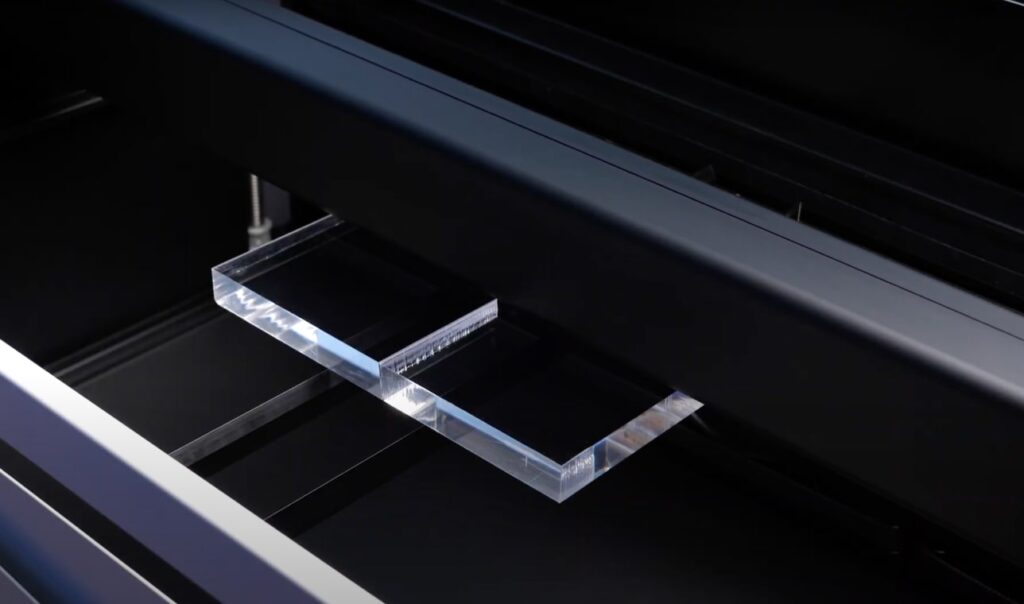 Laser cutting through acrylic material